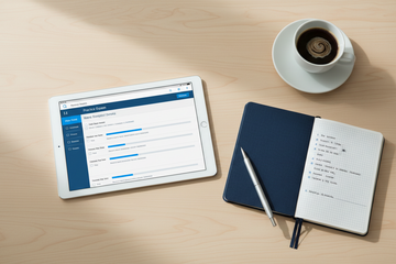 Clean study desk with tablet showing SIE practice exam, notebook, pen, and coffee